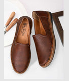 Men's brown ethnic loafer shoes with synthetic leather and slip-on design.